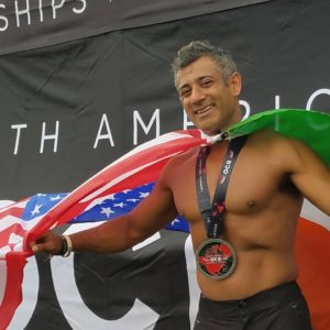 Akash Garg with a flag around his shoulders after spartan race