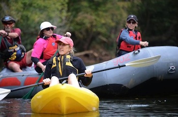 group kayaking and canoeing on a river