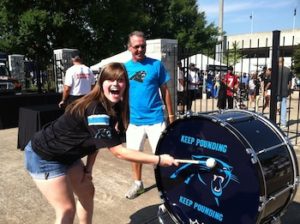 fan playing the drum at carolina panthers training camp