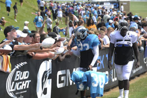 football player with fans at carolina panthers training camp