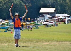 man directing flyers at triple tree aerodrome